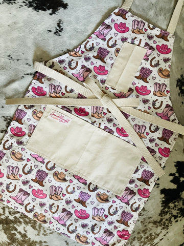 Cowboy pattern apron with pink cowboy boots pink cowboy hat horseshoes hearts Amanda Bright Designs couture collection