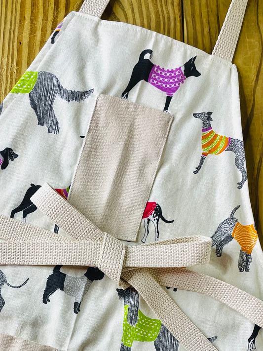 Amanda Bright Designs Pixie sweater wearing dog apron 