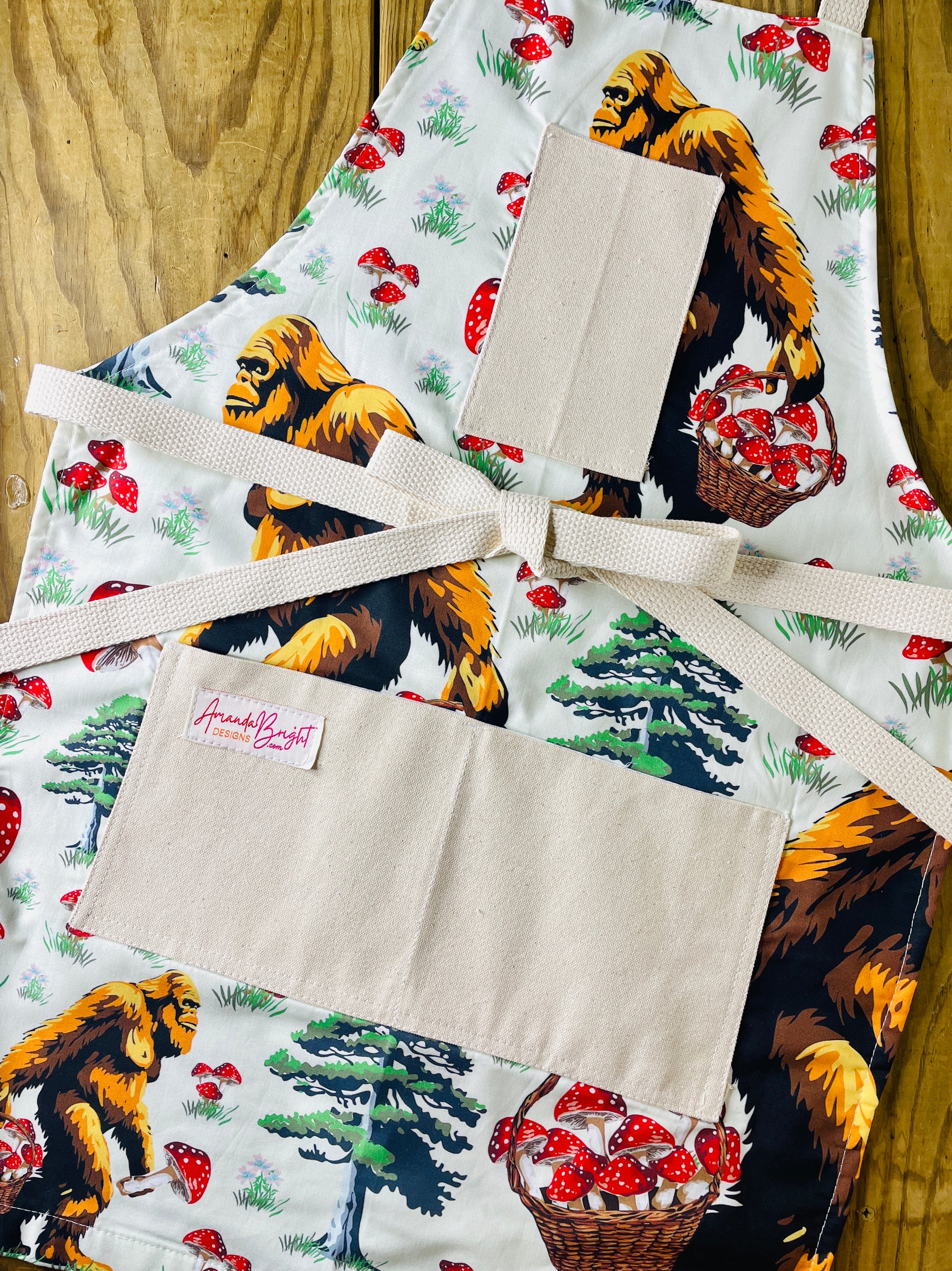 Apron with bigfoot carrying basket of mushrooms Amanda bright designs 