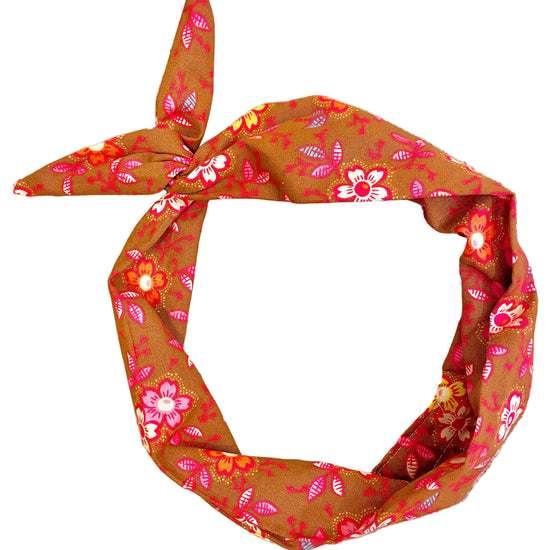 Amanda Bright Designs knotted cotton headband with a retro floral pattern in orange, pink, cinnamon and white