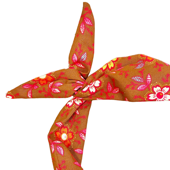 Amanda Bright Designs tie headband in fall colors of cinnamon with orange, pink, yellow and white flowers with a touch of baby blue