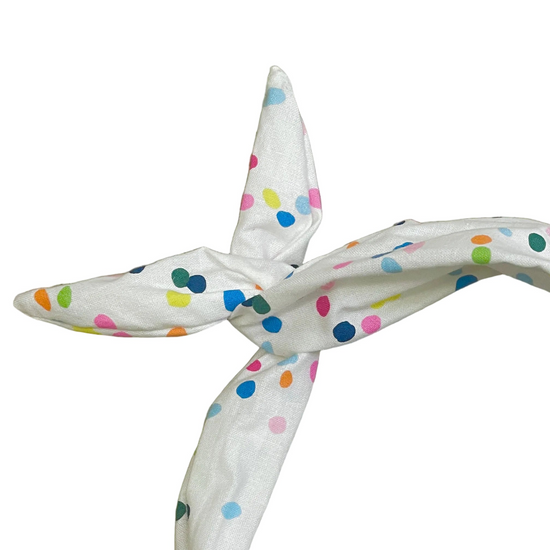 Amanda Bright Designs white cotton headband with a colorful polka dot pattern, tied in a knot 