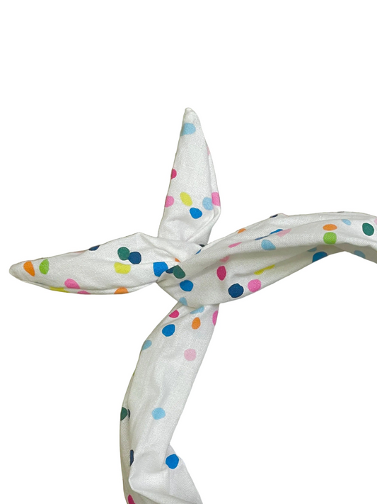 Amanda Bright Designs white cotton headband with a colorful polka dot pattern, tied in a knot 