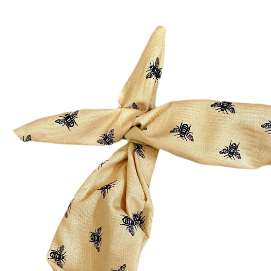 Amanda Bright Designs stylized navy blue honey bees on a khaki colored 100% cotton headband