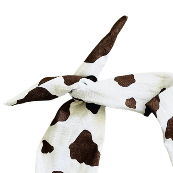 Amanda Bright Designs cotton fabric headband with a brown cow print pattern, tied in a knot at the top