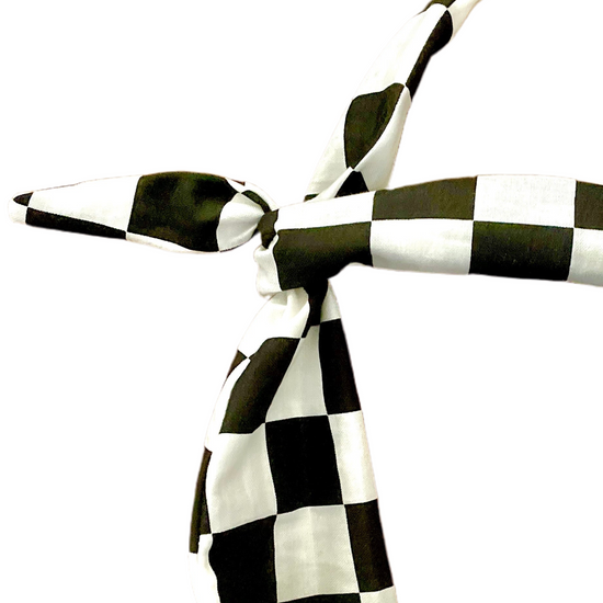 A black and white checkered headband tied in a knot amanda bright designs moldable bendable original tie headband