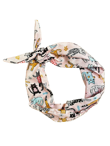 Amanda Bright Designs light pink fabric headband with a tie knot, featuring a playful cartoon cat animal print