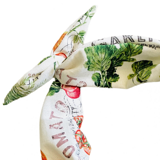 Amanda Bright Designs cotton headband featuring a vintage-style botanical and vegetable print on a cream background, with green leaves, red tomatoes, and orange pumpkins.