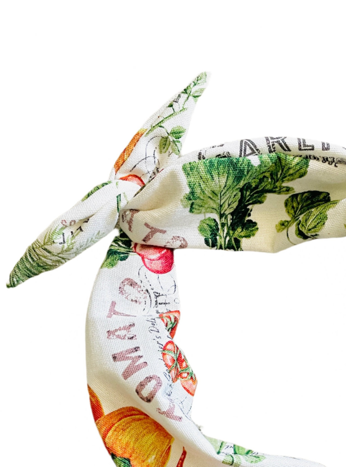 Amanda Bright Designs cotton headband featuring a vintage-style botanical and vegetable print on a cream background, with green leaves, red tomatoes, and orange pumpkins.