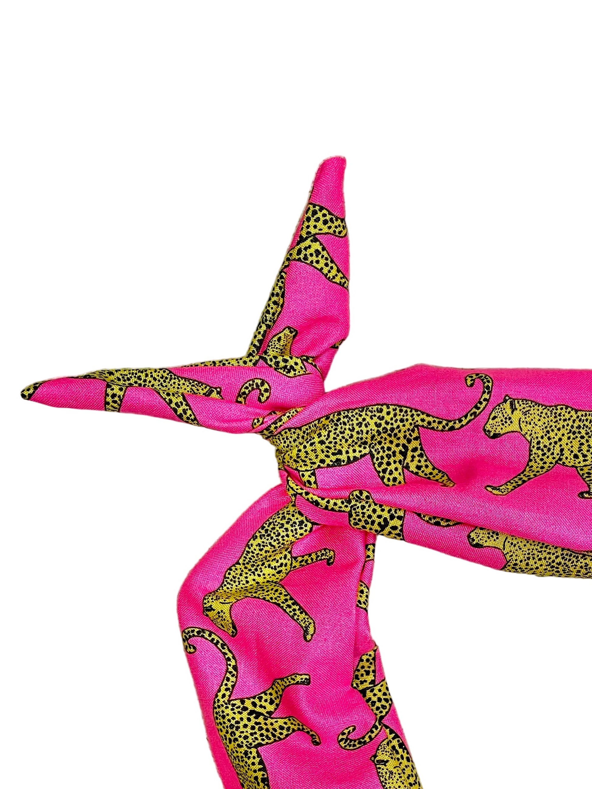 Amanda Bright Designs bright pink headband with a black and yellow leopard print styled in a knot