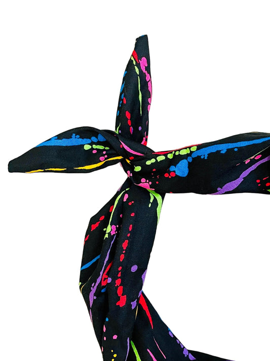 Amanda Bright Designs black headband with neon paint splatter close-up view