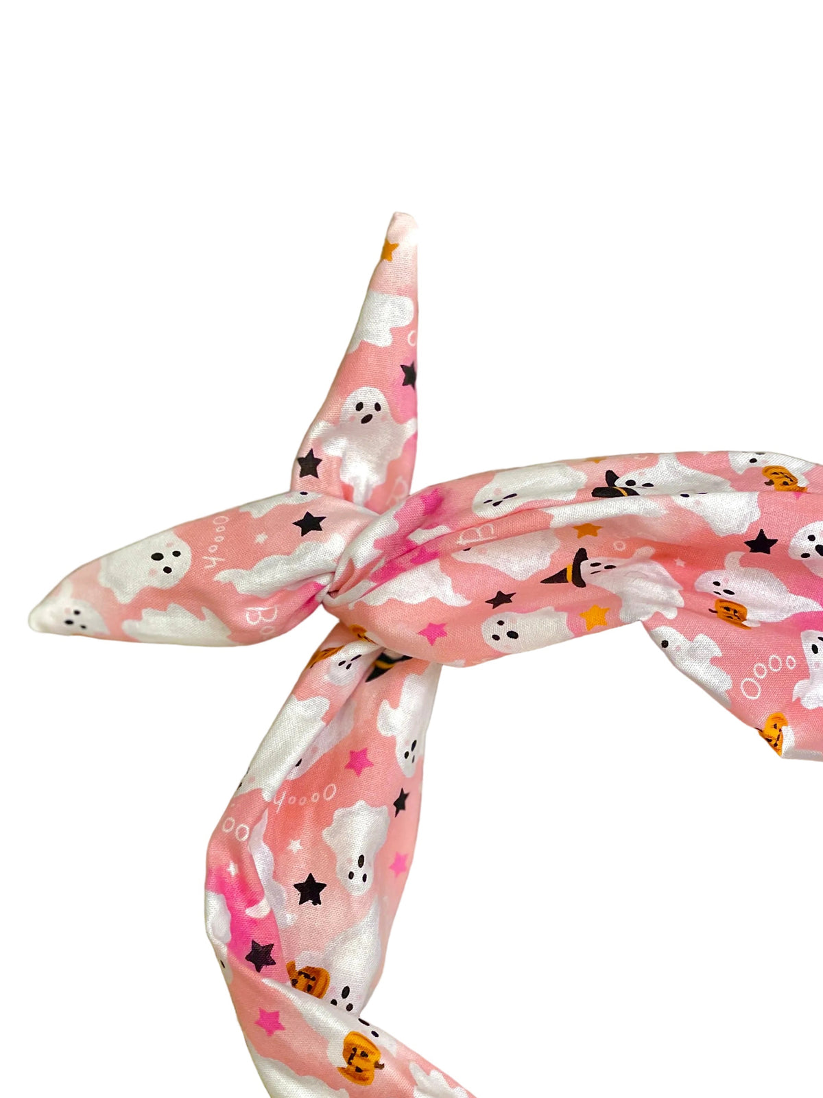 Amanda Bright Designs pink and white head headband with a Halloween print of ghosts, witches, pumpkins, and stars, styled in a knot twist
