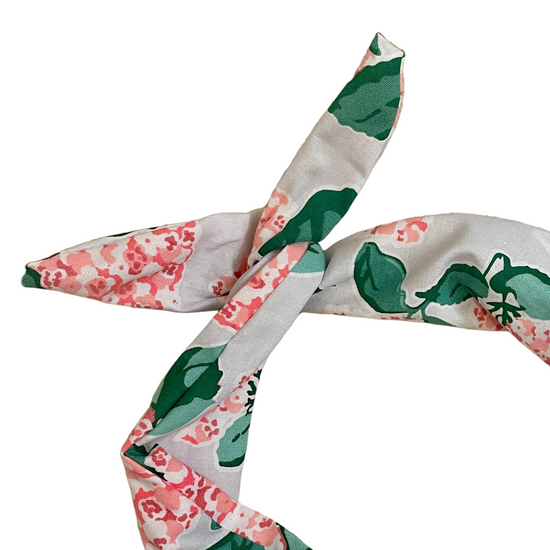 Amanda Bright Designs pink hydrangea floral headband with a floral and leaf pattern in green, pink, and white, styled in a loose knot 