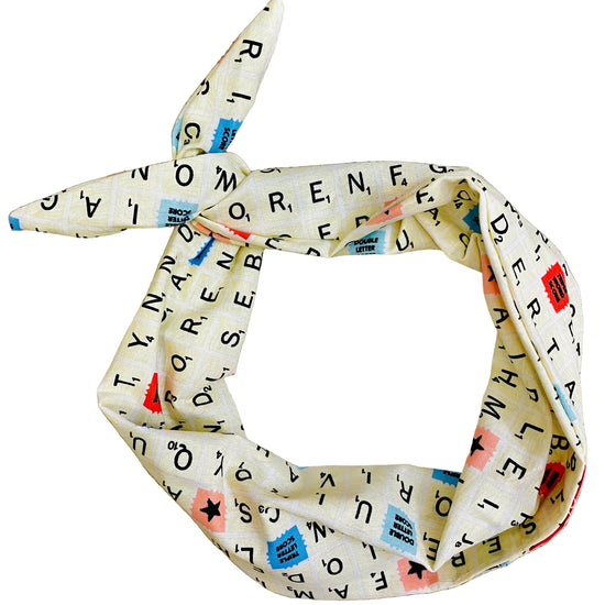 Amanda Bright Designs Word Games Headband featuring cream colored tiles with letters and brightly colored tiles from board game