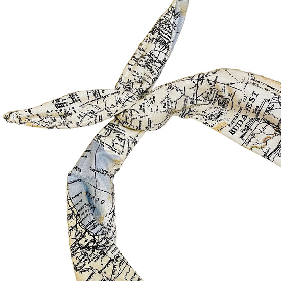 Map patterned headband tied in a knot on a white background