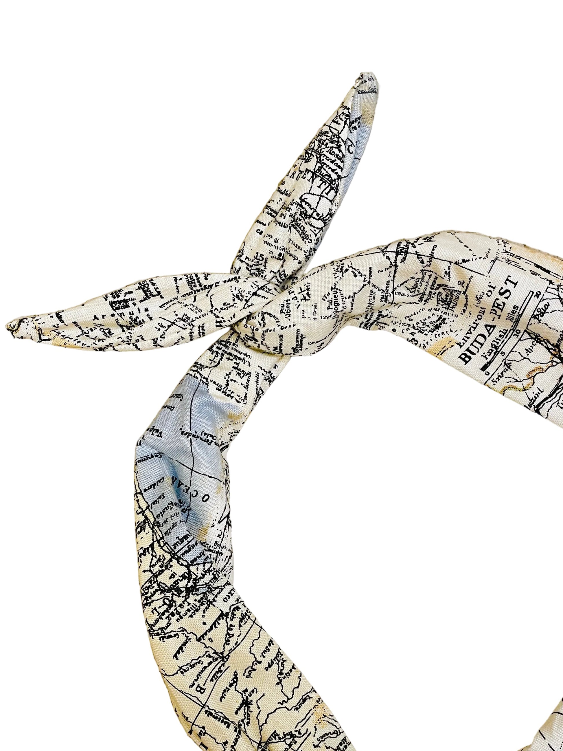 Map patterned headband tied in a knot on a white background