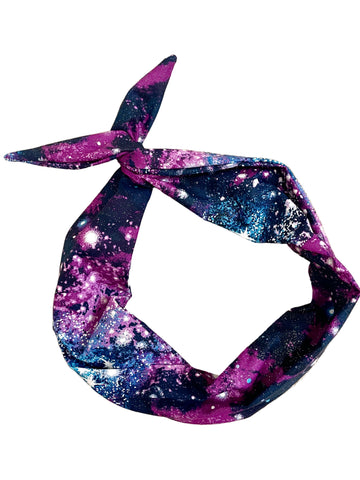 Amanda Bright Designs original tie headband space cosmos glitter headband for women in violet, magenta, midnight blue, and electric blue scattered with shimmering stars and celestial bursts, creating the look of a spectacular night sky