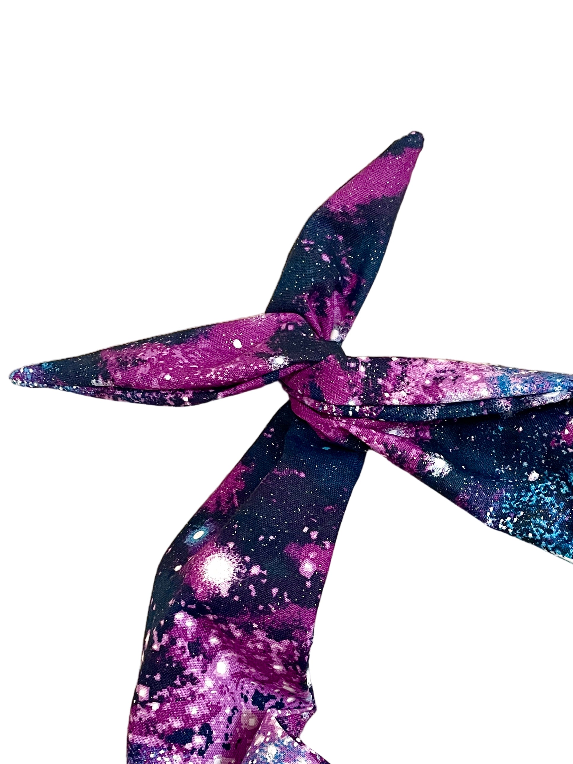 Amanda Bright Designs original tie headband space cosmos glitter headband for women in violet, magenta, midnight blue, and electric blue scattered with shimmering stars and celestial bursts, creating the look of a spectacular night sky and galaxy print