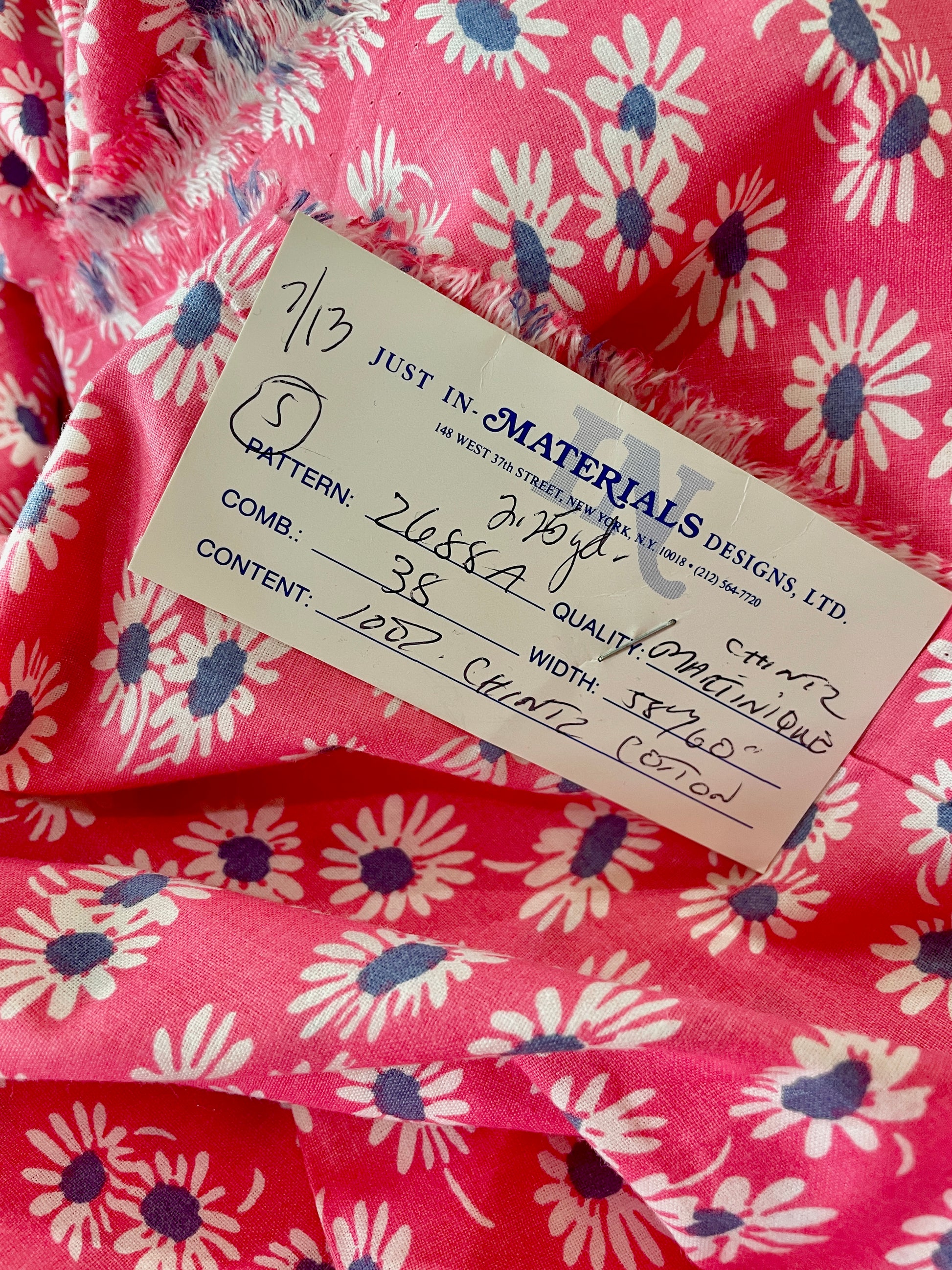Amanda Bright Designs Close-up of pink floral fabric with a label 
