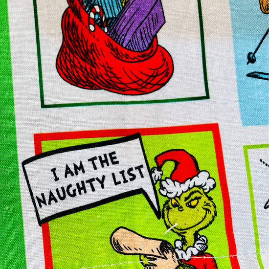 amanda bright designs feeling grinchy apron closeup of grinch in santa costume i am the naughty list