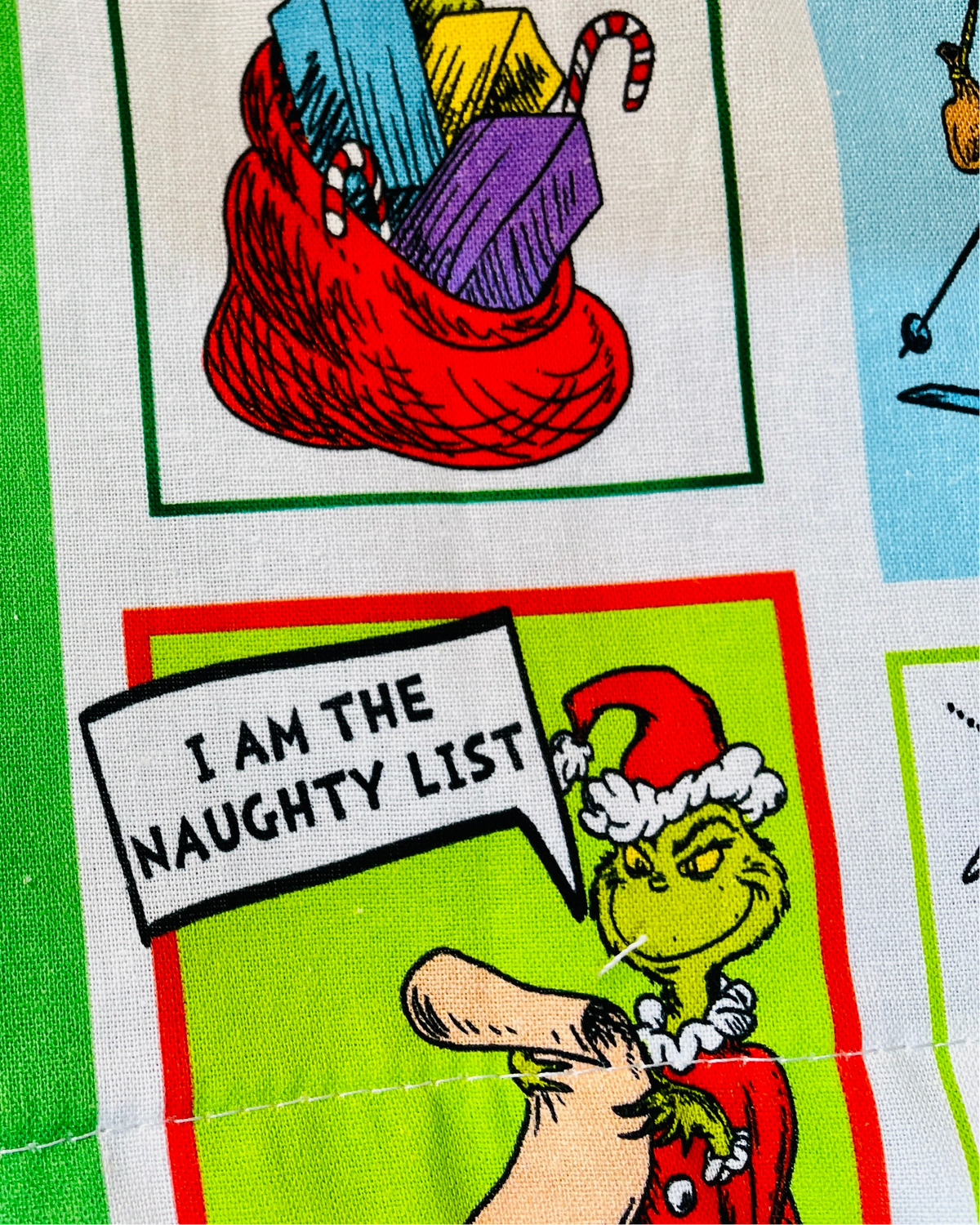 amanda bright designs feeling grinchy apron closeup of grinch in santa costume i am the naughty list