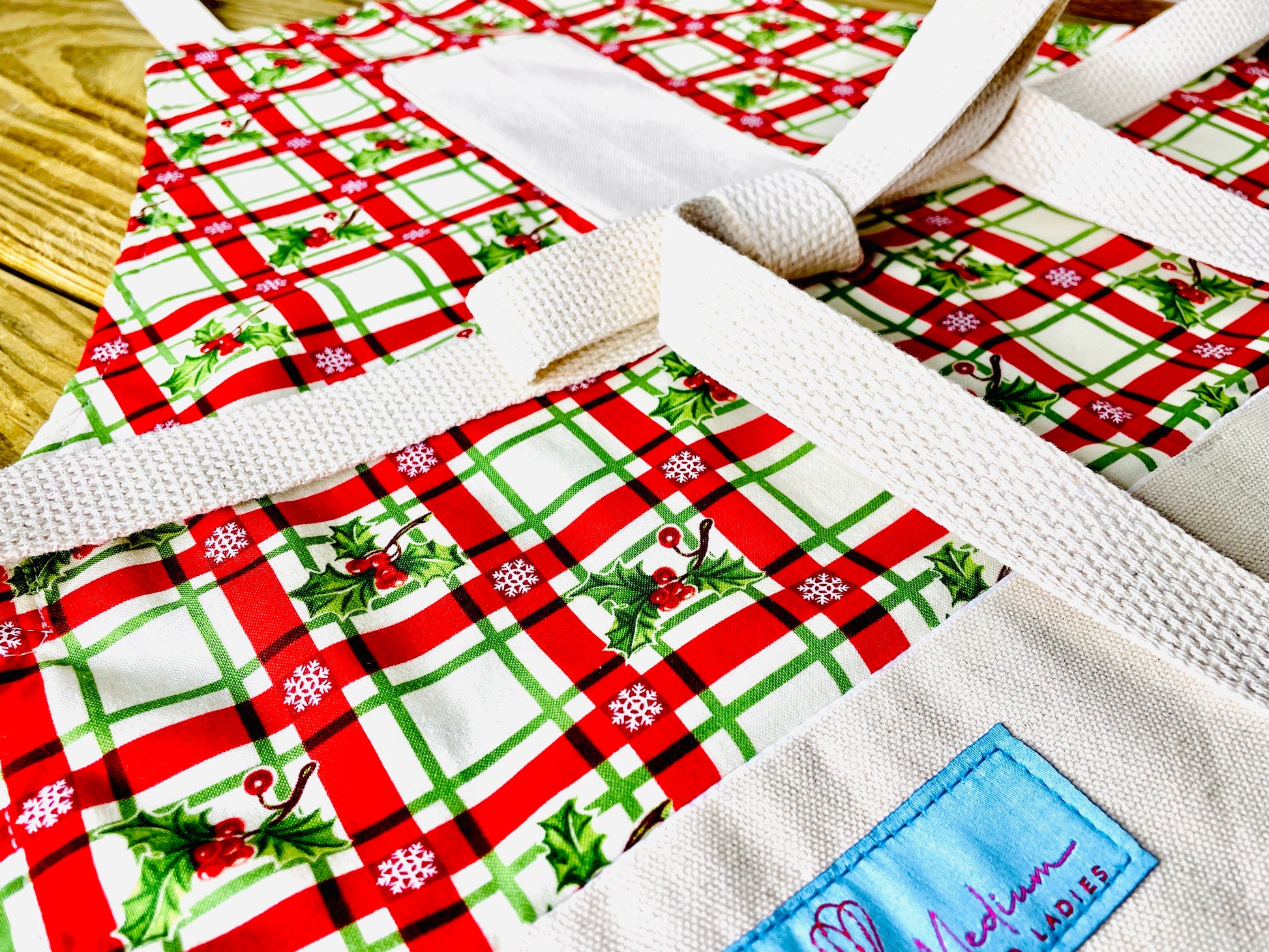 Two Medium Sized Ladies Christmas Plaid Red and Green Holly Berry Vintage Style Apron Close Up View