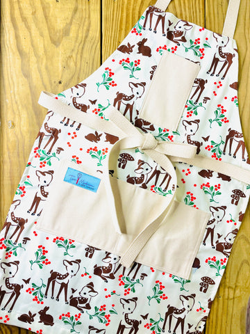 Two Medium Sized Ladies Reindeer Forest Fawn Apron featuring brown spotted fawns green holly red berries mushrooms butterflies