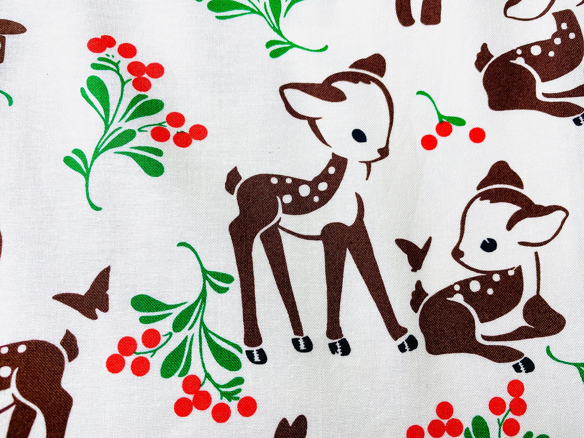 Two Medium Sized Ladies pattern for cotton apron Winter Forest Fawn featuring baby deer butterflies and green and red foliage