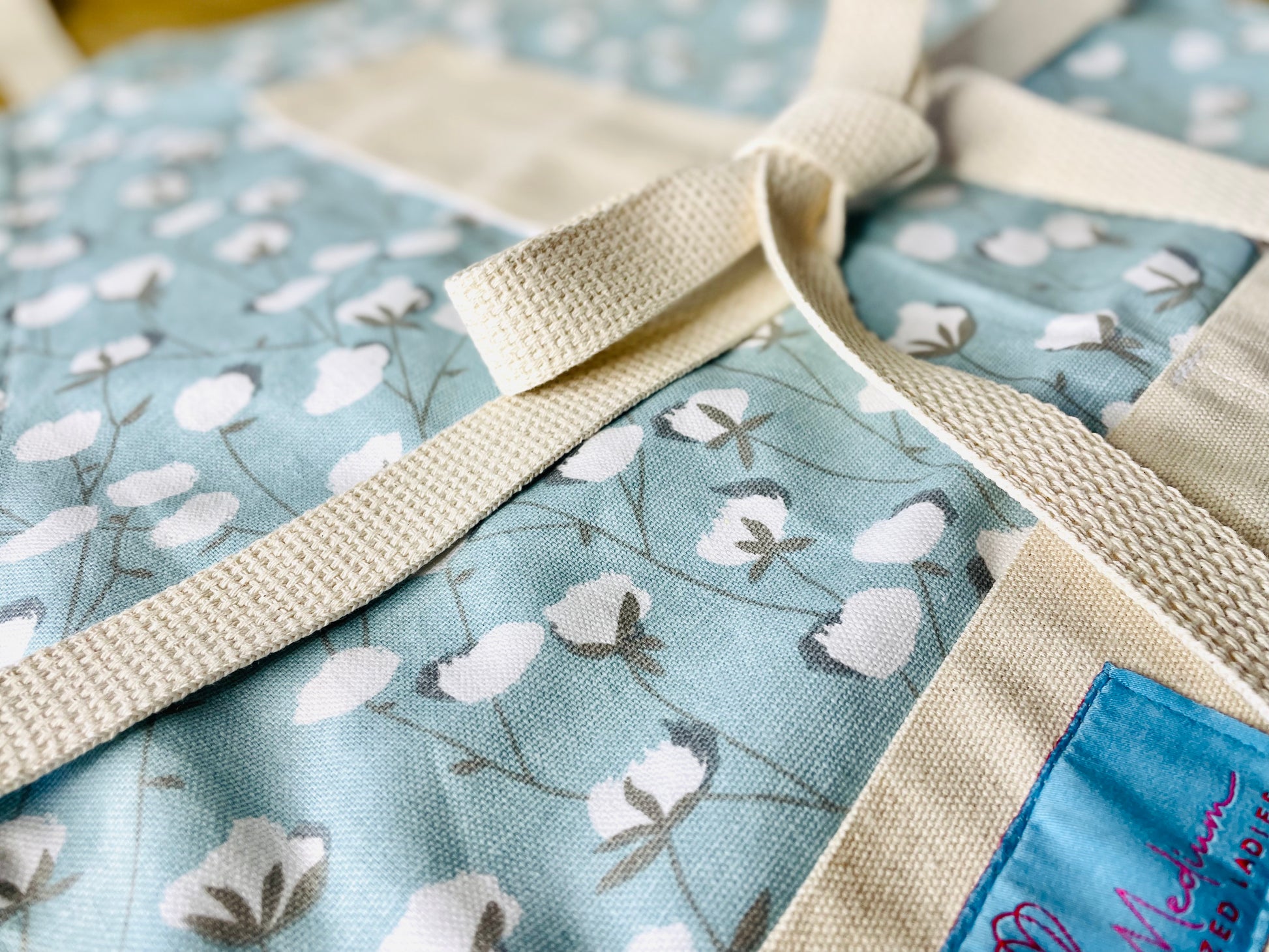 Two Medium Sized Ladies Texas cotton bowls sky blue women's apron pattern Ginny Cotton Gin closeup view of cotton raw crop