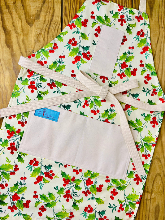 Two Medium Sized Ladies winter apron holly berry with bright red berries and holly tree leaves outdoor beauty Merry Christmas cardinals