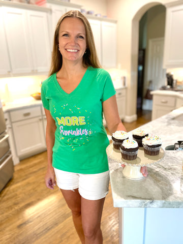 Two Medium Sized Ladies More Sprinkles green v neck cotton t-shirt with bubblegum pink and yellow stripe logo with sprinkles