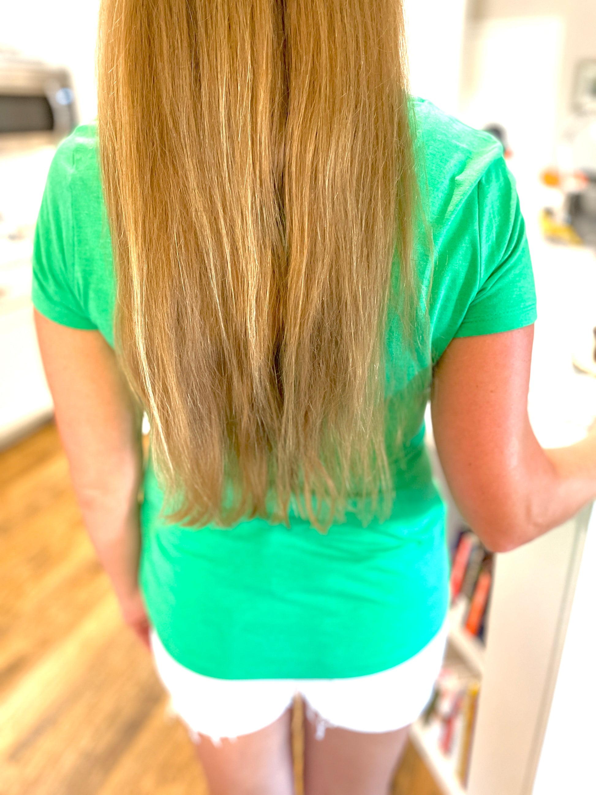 Two Medium Sized Ladies More Sprinkles back view green v neck cotton t-shirt with bubblegum pink and yellow stripe logo with cake sprinkles