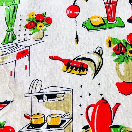 Amanda Bright Designs Lucille apron 1950s kitchen appliances pattern in red and green with red pockets and strings 