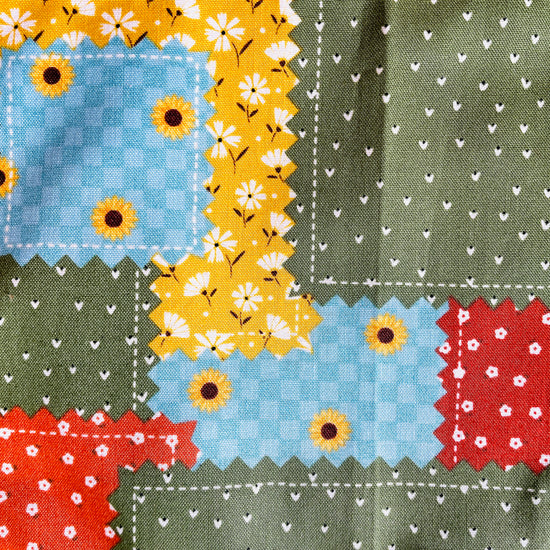 Two Medium Sized Ladies Maria Apron colorful patchwork quilt pattern in gold, green, burnt orange, cinnamon and aquamarine with sunflowers kitchen apron fabric pattern