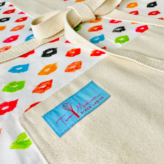 Two Medium Sized Ladies Marilyn Lipstick Apron Hollywood Glamour Icon red pink orange green blue black pouty lips closeup view
