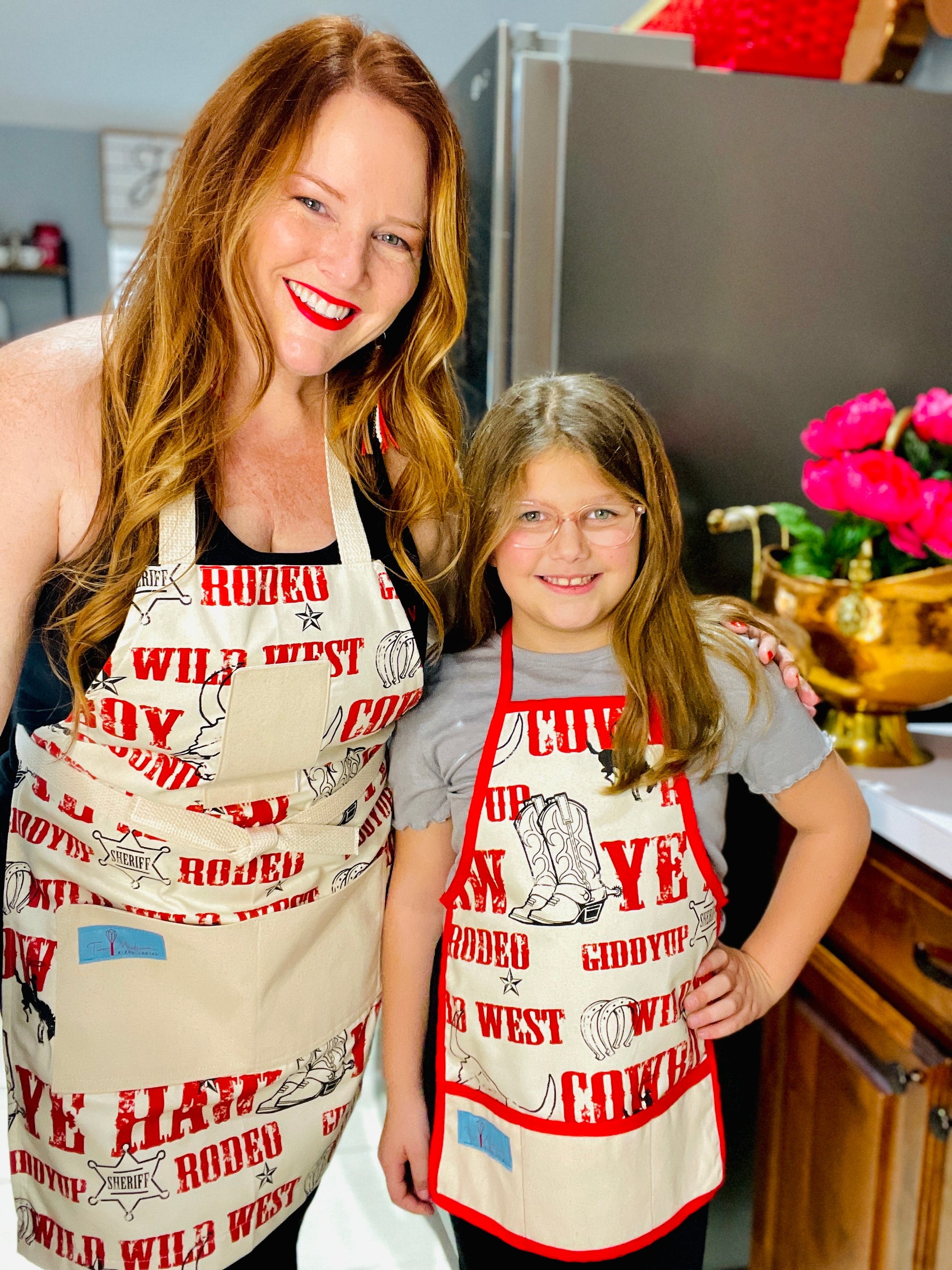 Two Medium Sized Ladies Mommy and Me Cowboy Apron Jane Long Mother of Texas boots, steer, sheriff badge, stars, horseshoes, roping cowboy, horse on mother and child