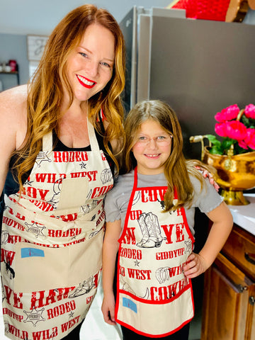 Two Medium Sized Ladies Mommy and Me Cowboy Apron Jane Long Mother of Texas boots, steer, sheriff badge, stars, horseshoes, roping cowboy, horse on mother and child