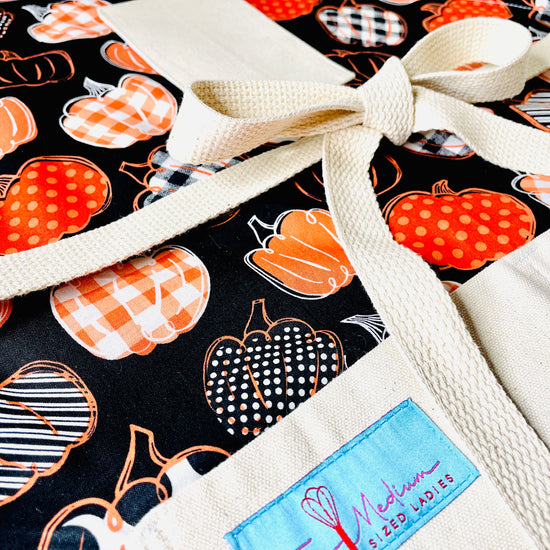 Amanda Bright Designs pumpkin spice everything black and orange closeup view of halloween farmhouse style apron