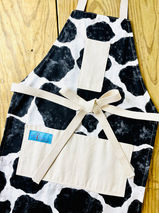 Two Medium Sized Ladies Susanna Apron cowhide black and white holstein Susanna Dickinson Lady of the Alamo modern farmhouse style kitchen