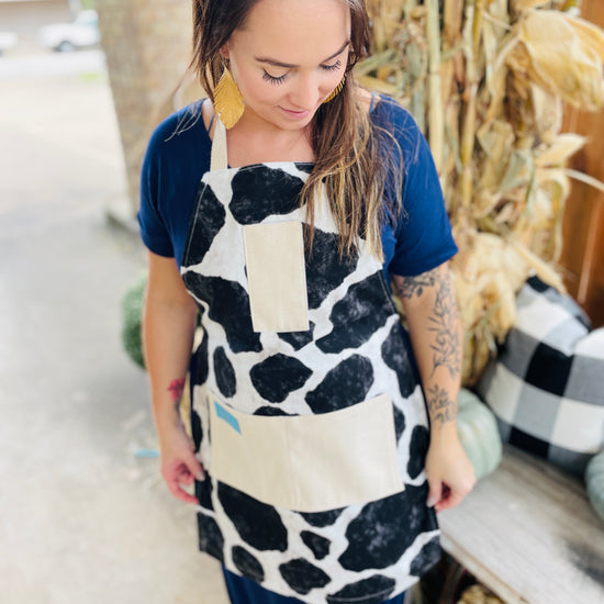 Susanna Apron cowhide black and white holstein Susanna Dickinson Lady of the Alamo model wearing cowprint apron