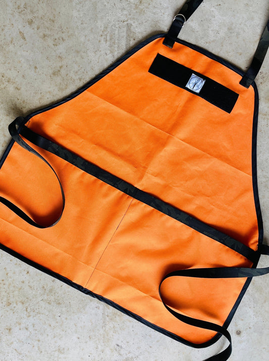 Amanda Bright Designs The Hunter Bright Orange Ottertex Waterproof Canvas Apron with black nylon webbing and strings towel loop